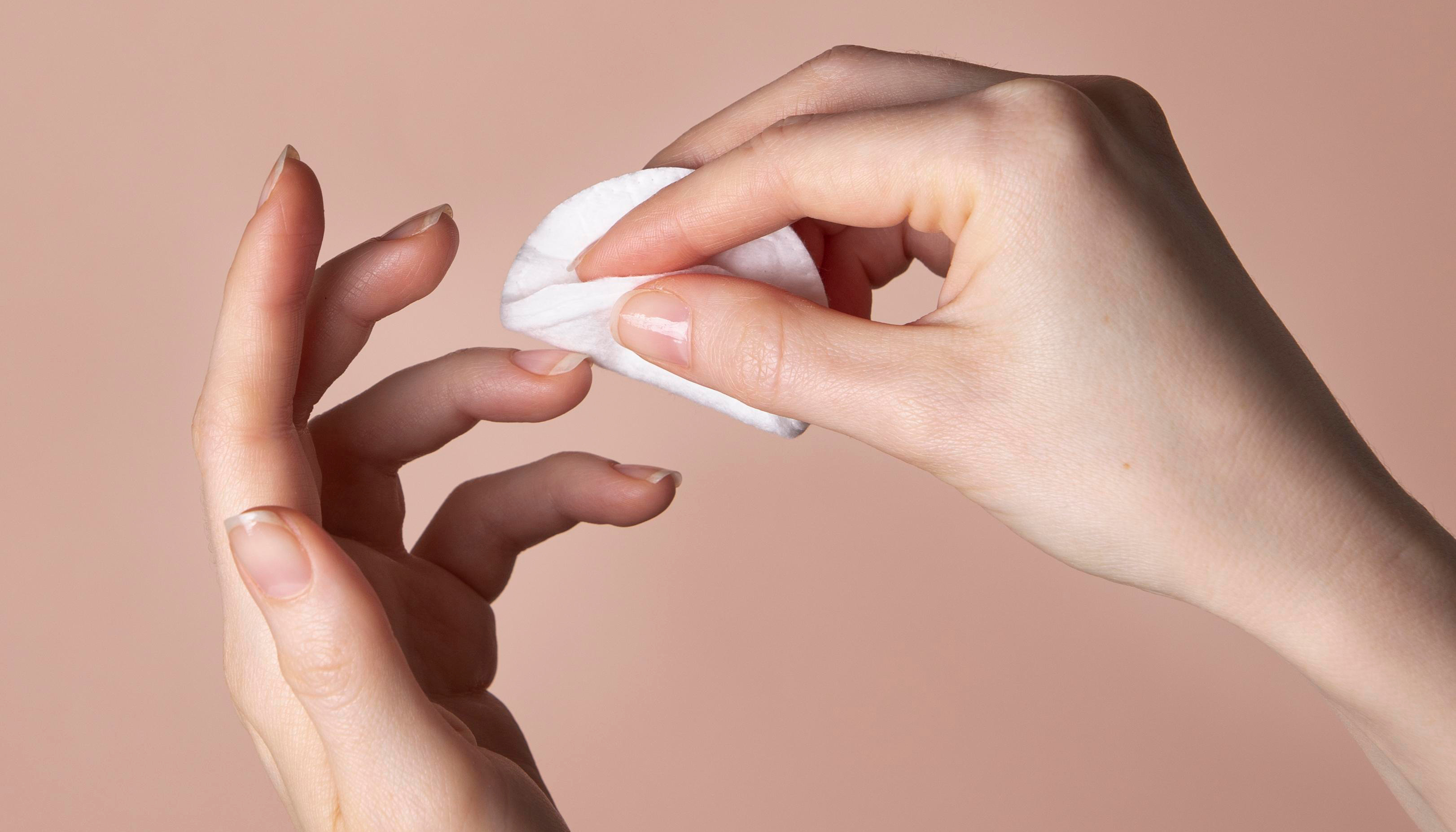 A person removing gel nail polish